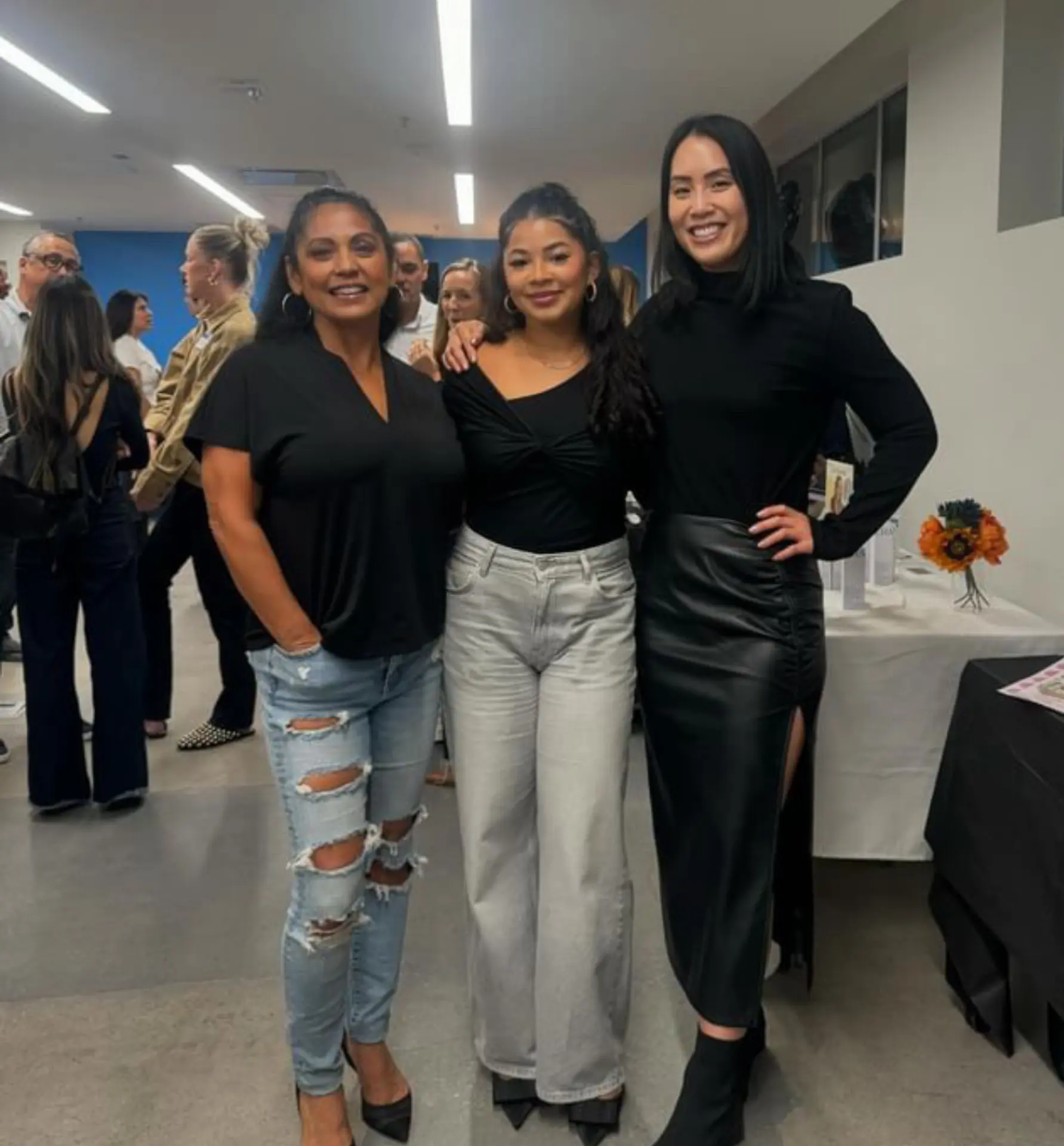 Maya with collaborators at an evening event